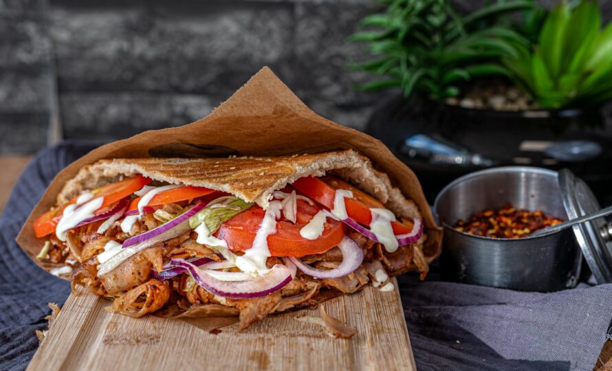 Turkish chicken doner kebab on wooden board