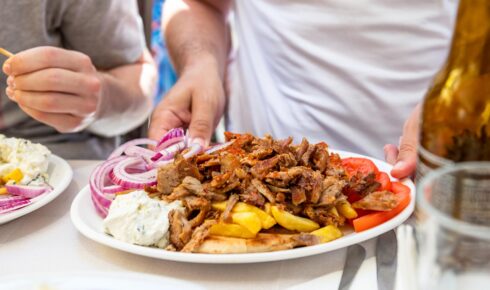 Kebab Beef Souvlaki in greek tavern Traditional Greek food served in tavern, made from Kebab Beef Souvlaki, french fries, salad and pita bread